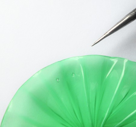 Adding holes to the plastic tree.