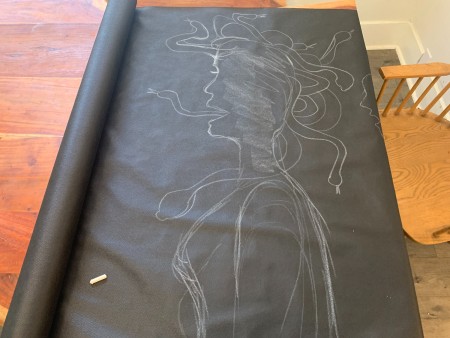 Tracing out the Medusa silhouette on a piece of landscaping fabric.