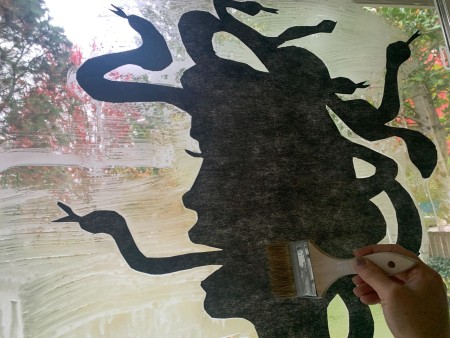 Gluing the silhouette to the window.