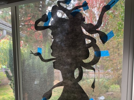 Taping the silhouette in place.