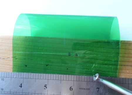 Marking the lines on a piece of plastic.