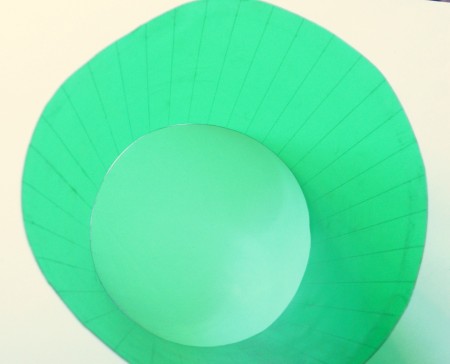 A cylinder of recycled green plastic.