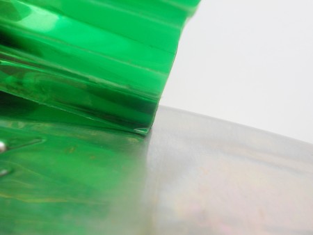 Melting the folded plastic edges.