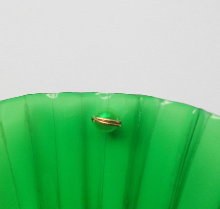 Adding pearls with wire to the plastic.