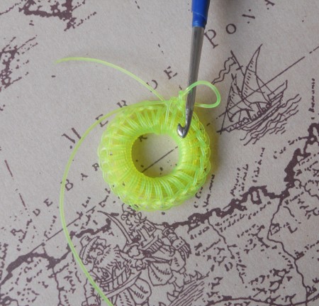 Crocheting the button from fishing line.