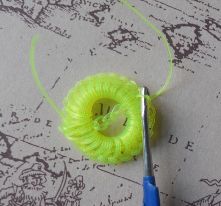 Crocheting the button from fishing line.