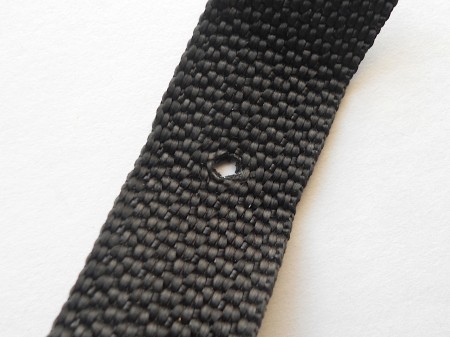 The whole for the buckle on the fabric belt.