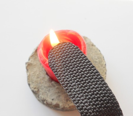 Melting the cut end of the fabric belt.