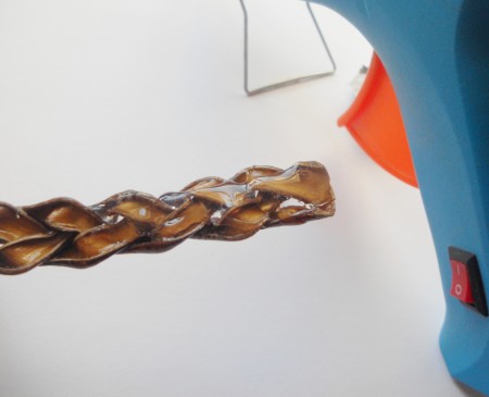Adding hot glue to the braided length.