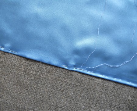 Sewing the seam on the blanket.