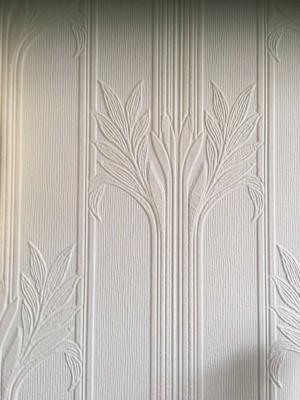 A decorative pattern on white wallpaper.