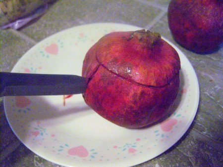 Cutting open a pomegranate.