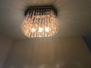 A decorative lightbulb in a ceiling fixture.