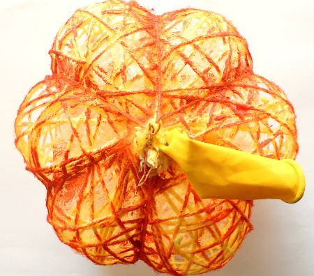 Adding orange color to the yarn.