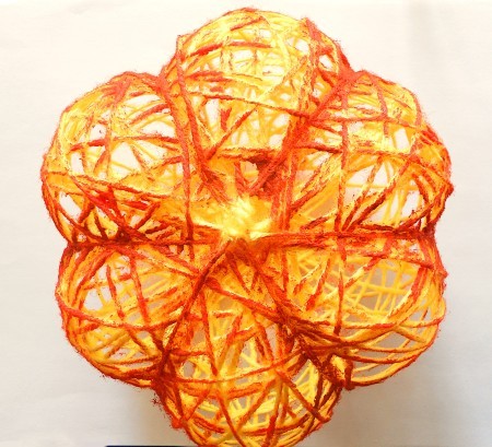 Adding orange color to the yarn.