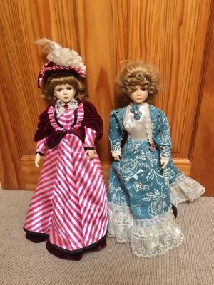 Two decorative porcelain dolls.
