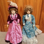 Two decorative porcelain dolls.