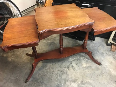 A three tier wooden table.