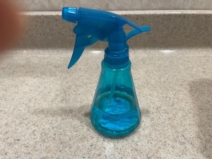 A spray bottle on a counter.