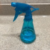 A spray bottle on a counter.