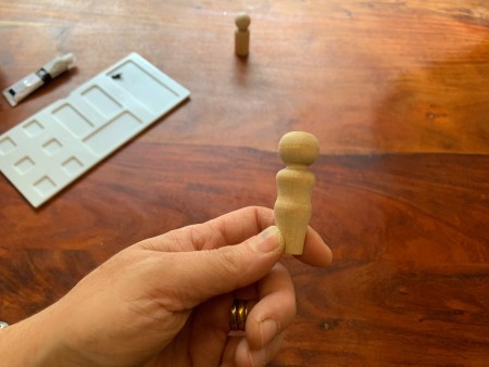 A wooden peg doll.