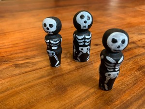 Three skeleton peg dolls.