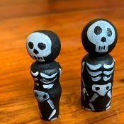 Three skeleton peg dolls.