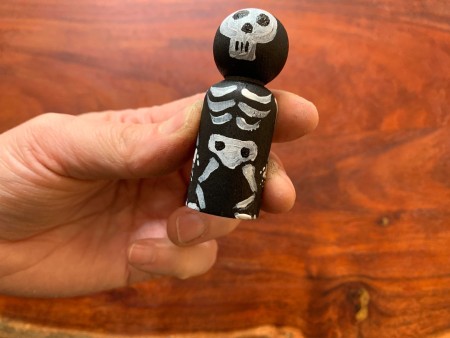 The completed painted skeleton peg doll.