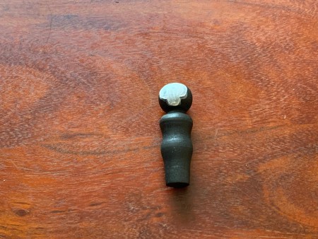 The skull shape on the peg doll.