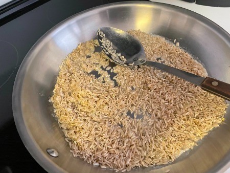 Cooking rice in a frying pan.