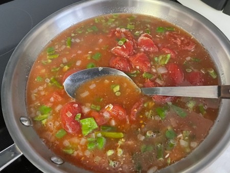 Adding liquids to the rice mixture.