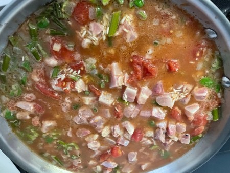 Adding chicken to the rice mixture.