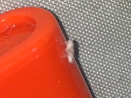 A white fuzz on a red item.
