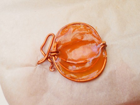 Using hot glue on the pumpkin.