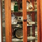 A tall cabinet with curiosities inside.