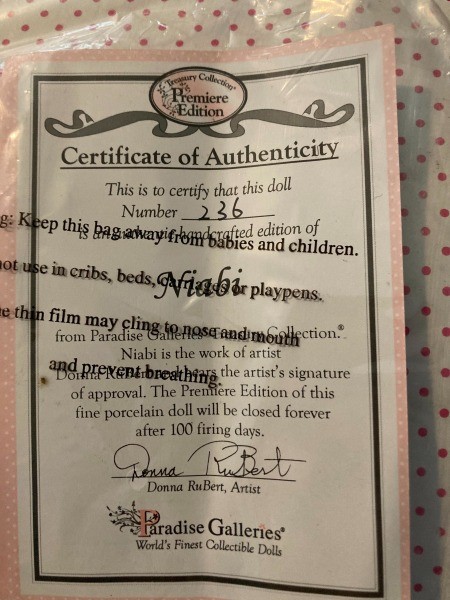 The certificate of authentication for a porcelain doll.