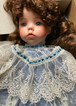 A dark haired porcelain doll.