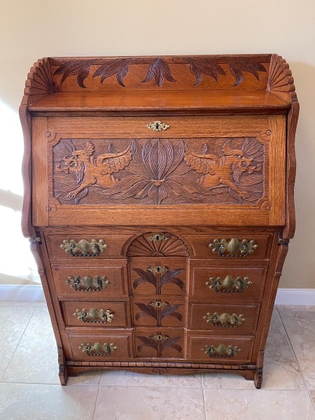 An ornately carved wooden desk.