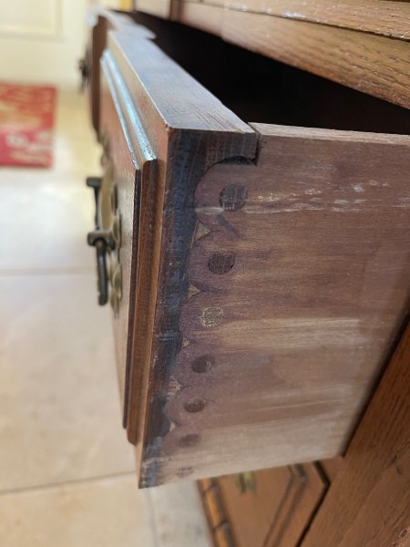 The drawers in a wooden desk.