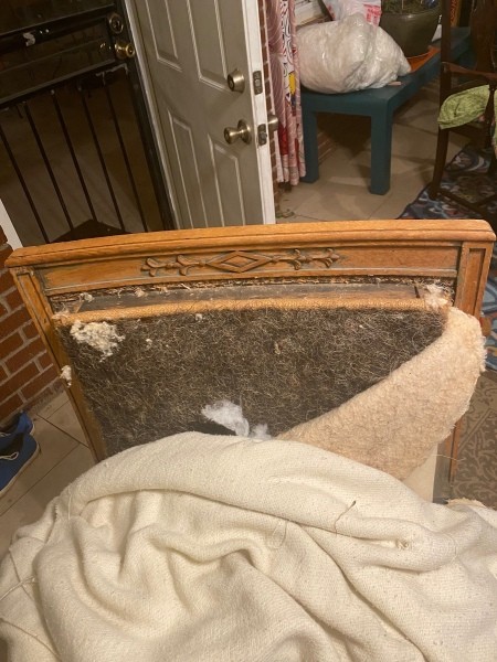 A stuffed armchair without upholstery.