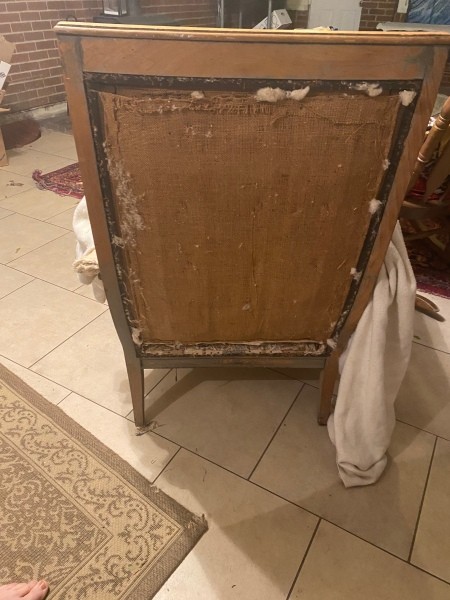 The back of a stuffed armchair without upholstery.