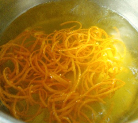 Cooking the orange peel in water.