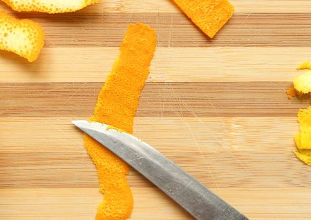 Cutting up the orange peel.