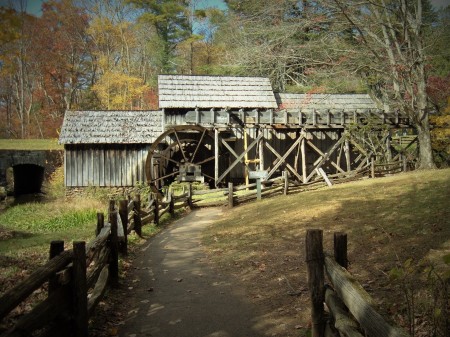An old wooden mill with a water wheel.