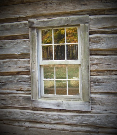 An old paned window in an old cabin.