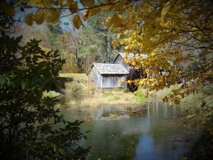 An old wooden mill with a water wheel.