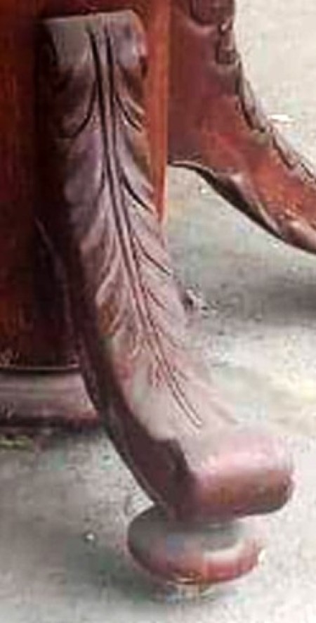 A close up of the carving on a table's legs.