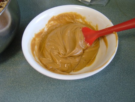 A bowl of smooth peanut butter.