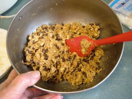 Mixing the peanut butter into the dry ingredients.