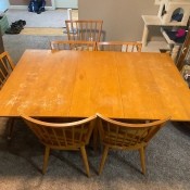 A wooden dining room set with 6 chairs.